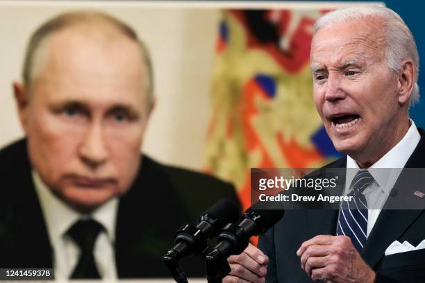 An image of Russian President Vladimir Putin is displayed as U.S. President Joe Biden speaks about gas prices in the South Court Auditorium at the...