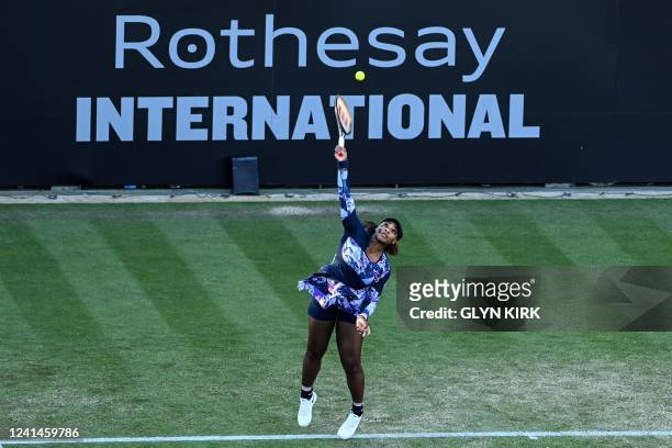Serena Williams of the US, playing with Tunisia's Ons Jabeur, serves the ball to Japan's Shuko Aoyama and Taiwan's Chan Hao-ching during their...