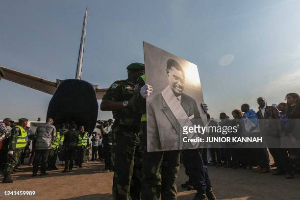 The coffin of slain Congolese independence leader Patrice Lumumba is carried by military personnel from an aircraft on arrival at Tshumbe in DRCongo...
