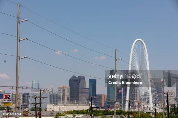 Power lines run in front of Margaret Hunt Hill Bridge in Dallas, Texas, US, on Tuesday, June 21, 2022. A heat wave has returned to parts of the South...