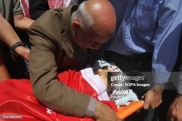 Father of the deceased gives his last farewell during the funeral of the 27-year-old Palestinian Ali Harb, who was stabbed to death by a Jewish...