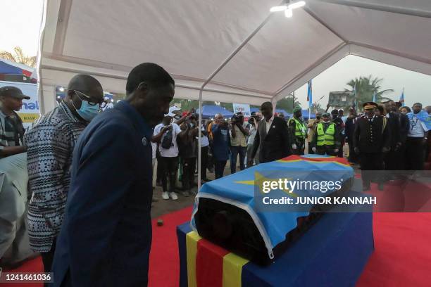 Guy-Patrice Lumumba the son of the slain Congolese independence leader Patrice Lumumba pays respects to the coffin of his father upon its arrival in...