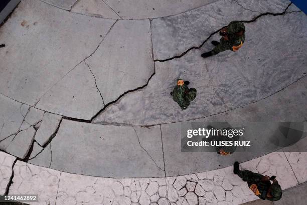 Members of the Mexican Army check cracks in the streets after an earthquake caused by a geological fault in Ciudad Guzman, Jalisco state, Mexico, on...