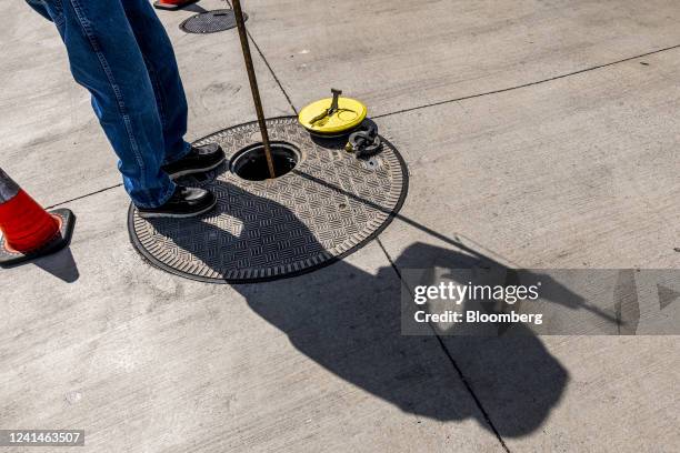 Fuel distributor checks the level of a gas storage tank at a Safeway gas station in Hercules, California, U.S., on Wednesday, June 22, 2022....