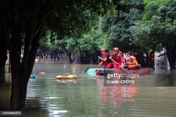 Firefighters ride kayaks to rescue people in Guilin, Guangxi Zhuang Autonomous Region, China, June 22, 2022.