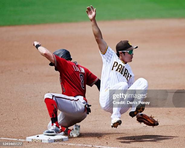 Jordan Luplow of the Arizona Diamondbacks is tagged out by Ha-Seong Kim of the San Diego Padres as he slides into third base during the fourth inning...