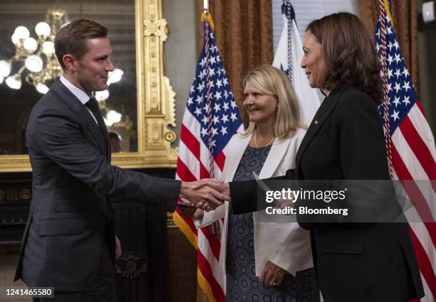 Vice President Kamala Harris swears in Scott Miller, US ambassador to Switzerland And Liechtenstein, as his mother Beverly Ann Miller holds a copy of...
