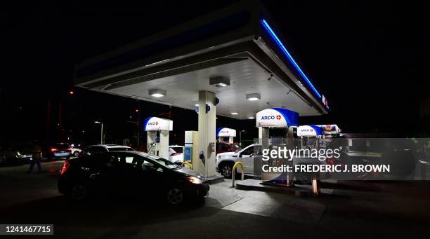 Cars pull in to fill their tanks at an Arco gas station displaying the price per gallon at over $6 in Monterey Park, California on June 22, 2022. Joe...