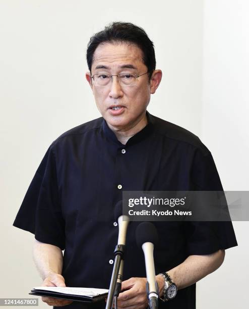 Japanese Prime Minister Fumio Kishida speaks to reporters after attending a memorial ceremony at the Peace Memorial Park in Itoman, Okinawa...