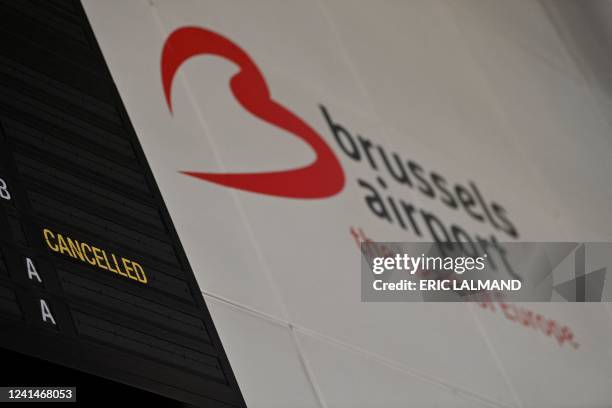 Illustration shows a logo of Brussels airport and a cancelled flight on the board in the departure hall of Brussels Airport, in Zaventem, Thursday 23...