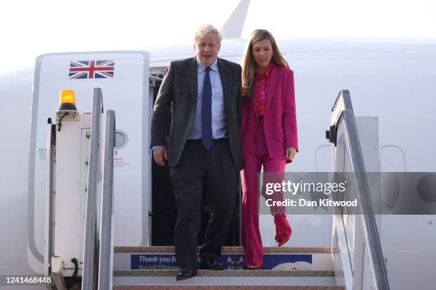 British Prime Minister Boris Johnson and his wife Carrie Johnson disembark from their plane as they arrive for the Commonwealth Heads of Government...