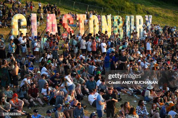 Festivalgoers attend the Glastonbury festival near the village of Pilton in Somerset, southwest England, on June 22, 2022. More than 200,000 music...