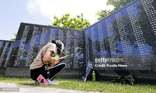 Child prays at a monument at the Peace Memorial Park in Itoman in Okinawa Prefecture, southern Japan, on June 23 the 77th anniversary of the end of...
