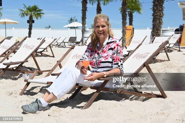 June 2022, North Rhine-Westphalia, Euskirchen: Presenter Maxi Biewer sits in a deck chair at the opening of the Beach Club at Therme Euskirchen. The...