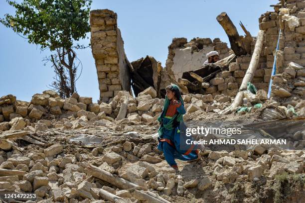 Child walks amidst the rubble of damaged houses following an earthquake in Bermal district, Paktika province, on June 23, 2022. Desperate rescuers...