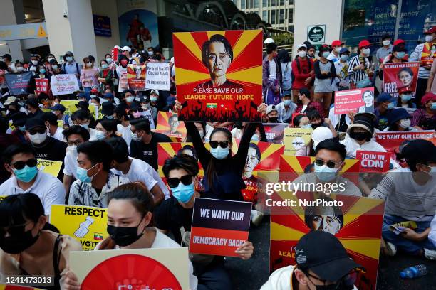 Myanmar protesters hold up placards with pictures of Aung San Suu Kyi during a demonstration against the military coup near Sule Pagoda in central...