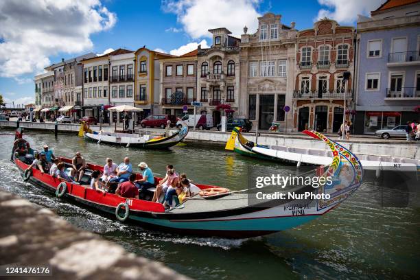 Tourists travel on traditional boats in Aveiro, Portugal on June 22, 2022.