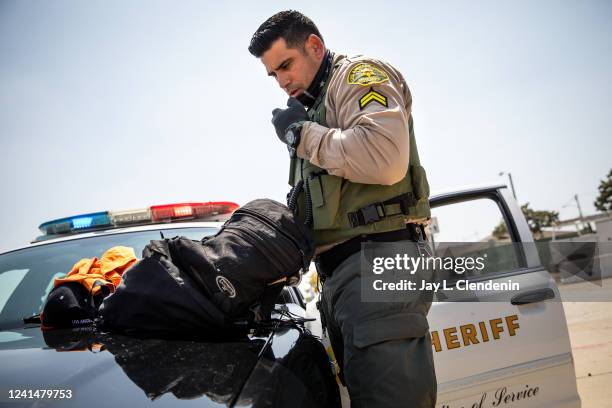 April 16: Los Angeles County Sheriffs deputy Manan Butt searches the property of a man he detained matching the description from a nearby assault,...