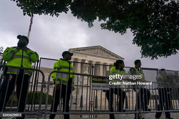 Capitol Police watch an abortion-rights rally from behind the security fence surrounding the Supreme Court on June 23, 2022 in Washington, DC. The...