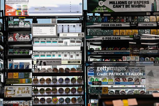 Labs Inc. Vaping e-cigarette products are displayed in a convenience store alongside cigarettes, vapes, and other smokeless chewing tobacco products...