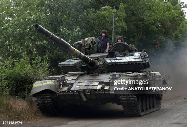 Ukrainian soldiers ride a tank on a road of the eastern Luhansk region on June 23 amid Russia's military invasion launched on Ukraine. - On the road...