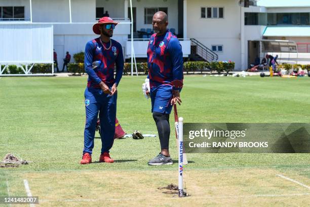 Kraigg Brathwaite and Phil Simmons of West Indies take a look at the pitch during a training session one day ahead of the 2nd Test between Bangladesh...