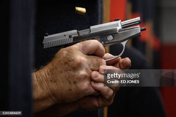 Shooting range owner John Deloca aims his pistol at his range in Queens, New York on June 23, 2022. - The US Supreme Court ruled June 23, 2022 that...