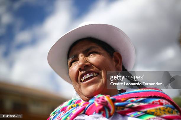 Woman wearing traditional clothes smiles during the parade of saints in the central square of Cusco ahead of the celebration of the Inti Raymi Sun...