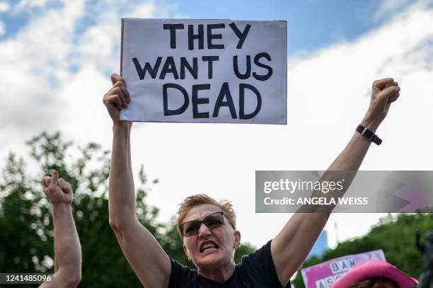 Protester holds a sign that reads "They Want Us Dead" during a protest against gun violence by the activist group "Gays against Guns" in New York...