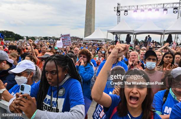Payton Ziegler of Washington, D.C., bottom right, raises her hand as she cheers during a speech in the March For Our Lives rally at The National Mall...
