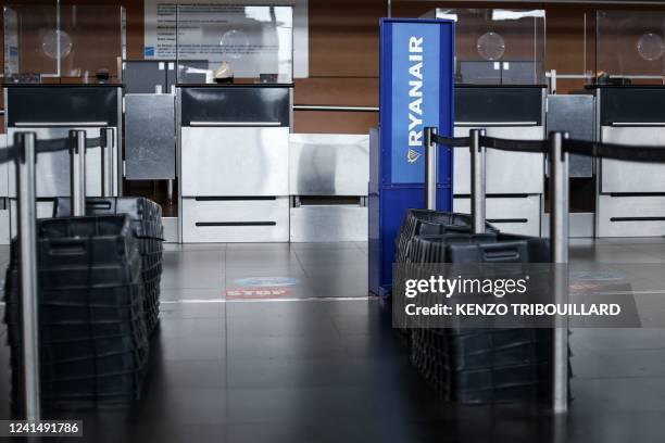 Picture taken on June 24, 2022 at the departure hall Terminal 1 of Charleroi Airport, in Charleroi shows empty Ryanair desk during a RyanAir cabin...