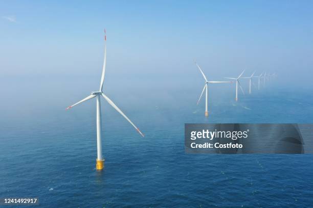 Photo taken on June 24, 2022 shows the operation of an offshore wind turbine at the South Wind Farm on the Shandong Peninsula. On June 24 the...