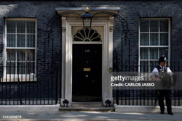 Police officer stands outside 10 Downing Street in London on June 24, 2022. - British Prime Minister Boris Johnson refused to heed renewed demands to...