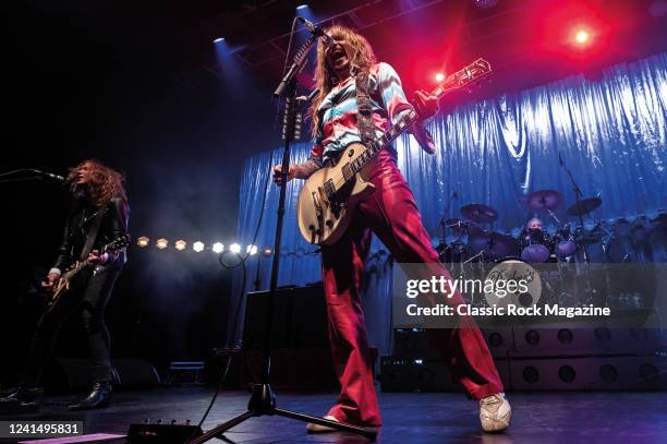 Guitarists Justin Hawkins and Dan Hawkins of British rock group The Darkness performing live on stage at the Brighton Dome in Brighton, England, on...