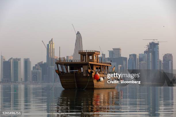 Traditional dhow boat moored in the water in front of residential and commercial skyscrapers in Doha, Qatar, on Thursday, June 23, 2022. About 1.5...