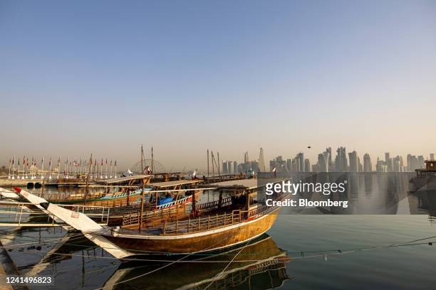 Traditional dhow boats moored in the water in front of residential and commercial skyscrapers in Doha, Qatar, on Thursday, June 23, 2022. About 1.5...