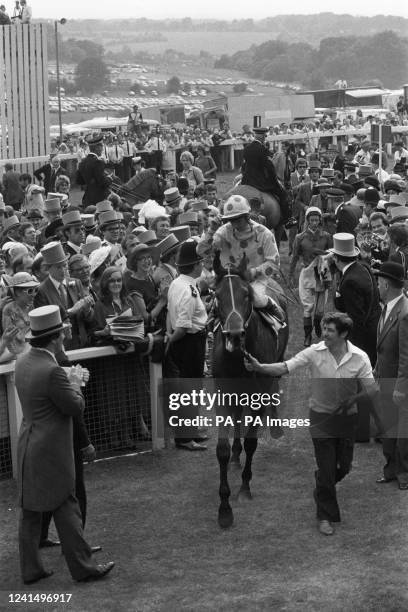 Willie Carson is led in on Henbit after the bay colt had given him and Berkshire-based trainer Dick Hern their second consecutive win in the Epsom...