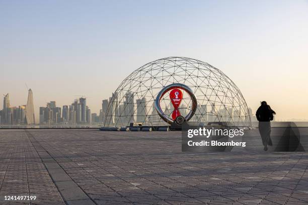 Resident jogs alongside a countdown installation for the upcoming 2022 FIFA World Cup in Doha, Qatar, on Thursday, June 23, 2022. About 1.5 million...