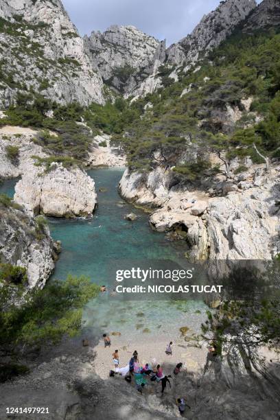 Hikers and tourists enjoy the calanque de Sugiton in the Parc national des calanques in Marseille, southern France, on June 24, 2022. Reservations...
