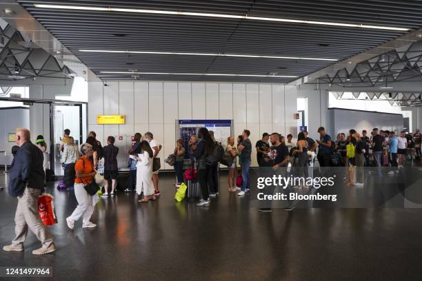 Travelers queue at a customer service center for Deutsche Lufthansa AG at Terminal 1 of Frankfurt Airport in Frankfurt, Germany, on Friday, June 24,...