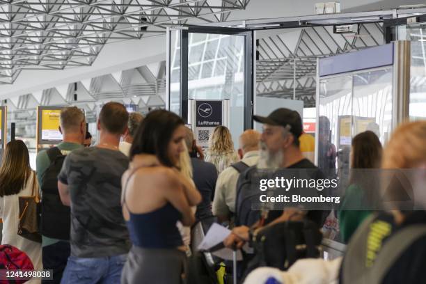 Travelers queue at a customer service center for Deutsche Lufthansa AG at Terminal 1 of Frankfurt Airport in Frankfurt, Germany, on Friday, June 24,...