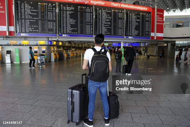 Traveler look at an information board in a near-empty departures hall at Terminal 1 of Frankfurt Airport in Frankfurt, Germany, on Friday, June 24,...