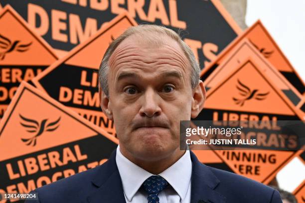 Britain's centrist Liberal Democrats party leader Ed Davey grimaces while addressing supporters in Tiverton as they celebrate the party's historical...