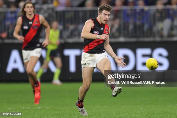 Zach Merrett of the Bombers kicks the ball during the 2022 AFL Round 15 match between the West Coast Eagles and the Essendon Bombers at Optus Stadium...