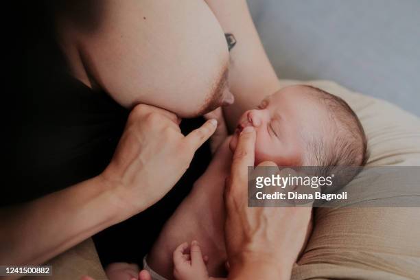 Woman with her newborn baby is provided with home breastfeeding assistance by midwife Anna Ruocco on June 17, 2022 in Turin, Italy. The "Prima Luce"...