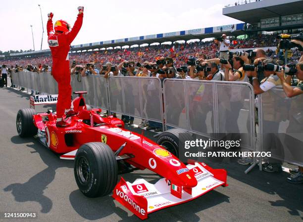 German Ferrari driver Michael Schumacher jubilates after winning the pole-position at the end of the qualifying session, 27 July 2002 in the pits of...