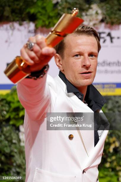 Alexander Scheer poses after winning his award for best male actor in a supporting role in Rabiye Kurnaz Vs. George W. Bush at the 72nd Lola - German...