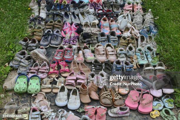 Children's shoes at a small memorial outside the Ontario Legislative Building after the discovery of the remains of 215 Indigenous children found...