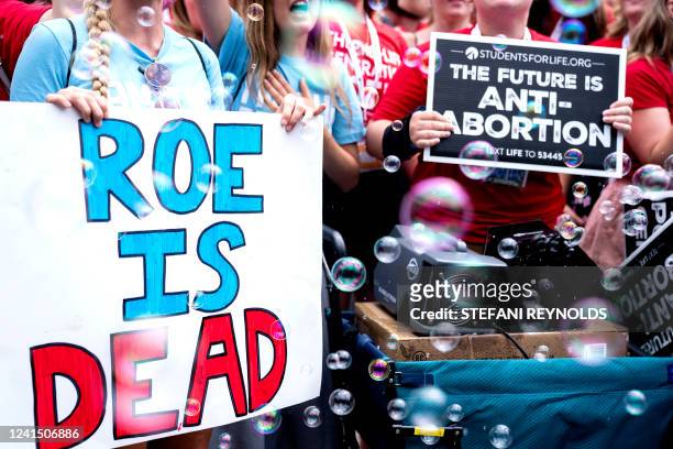 Anit-abortion activists hold signs outside the US Supreme Court after overturning of Roe Vs. Wade, in Washington, DC, on June 24, 2022.