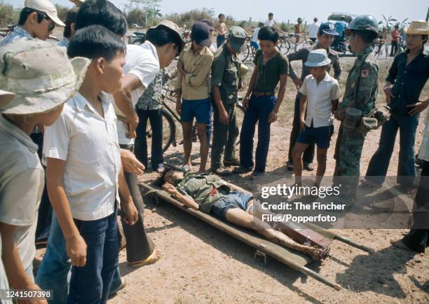 Dead North Vietnamese Officer lays on a stretcher in the aftermath of the Battle of Xuan Loc, the last major battle of the Vietnam War which ended in...